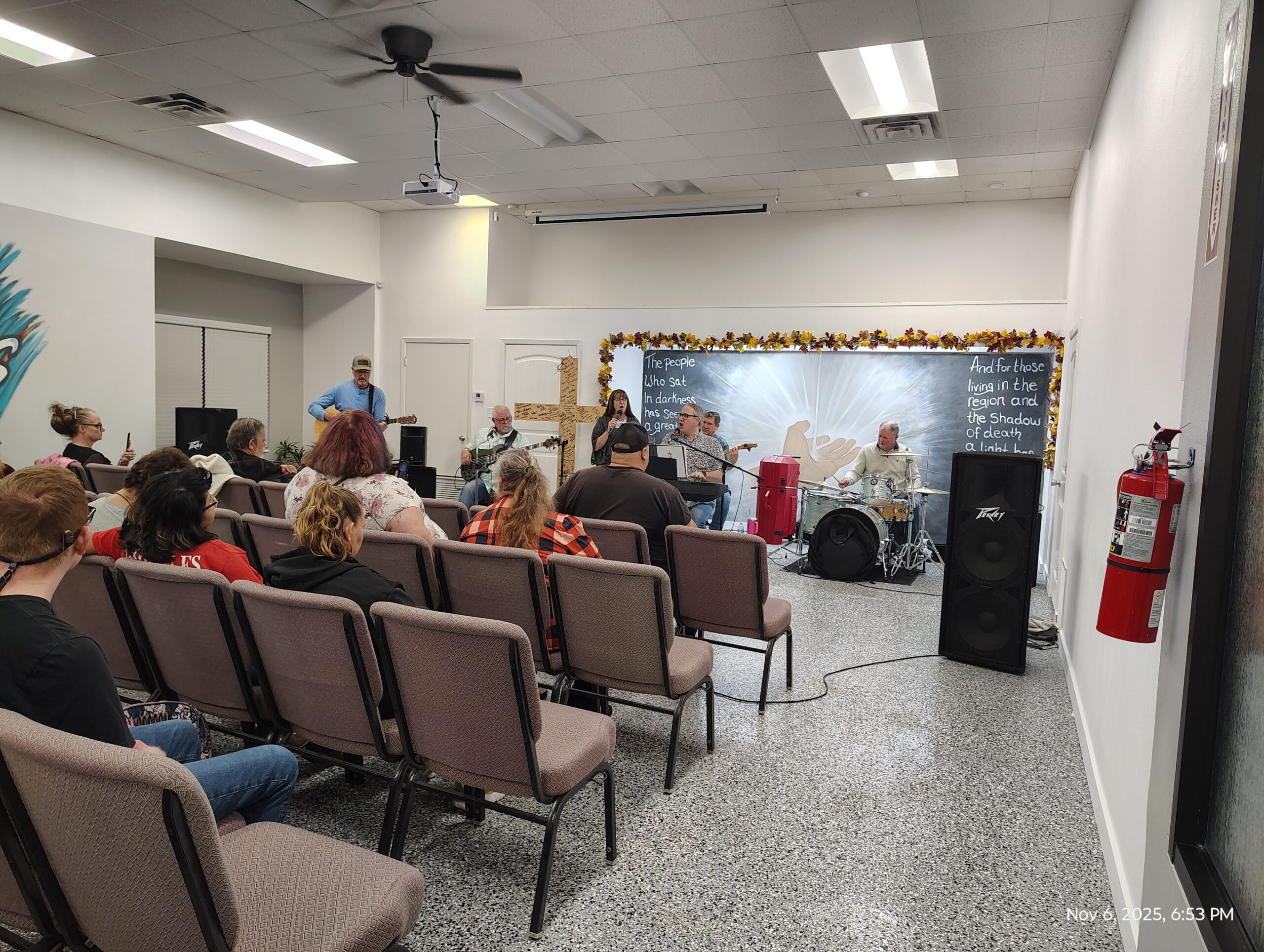 Musicians and congregation gathered for worship indoors.